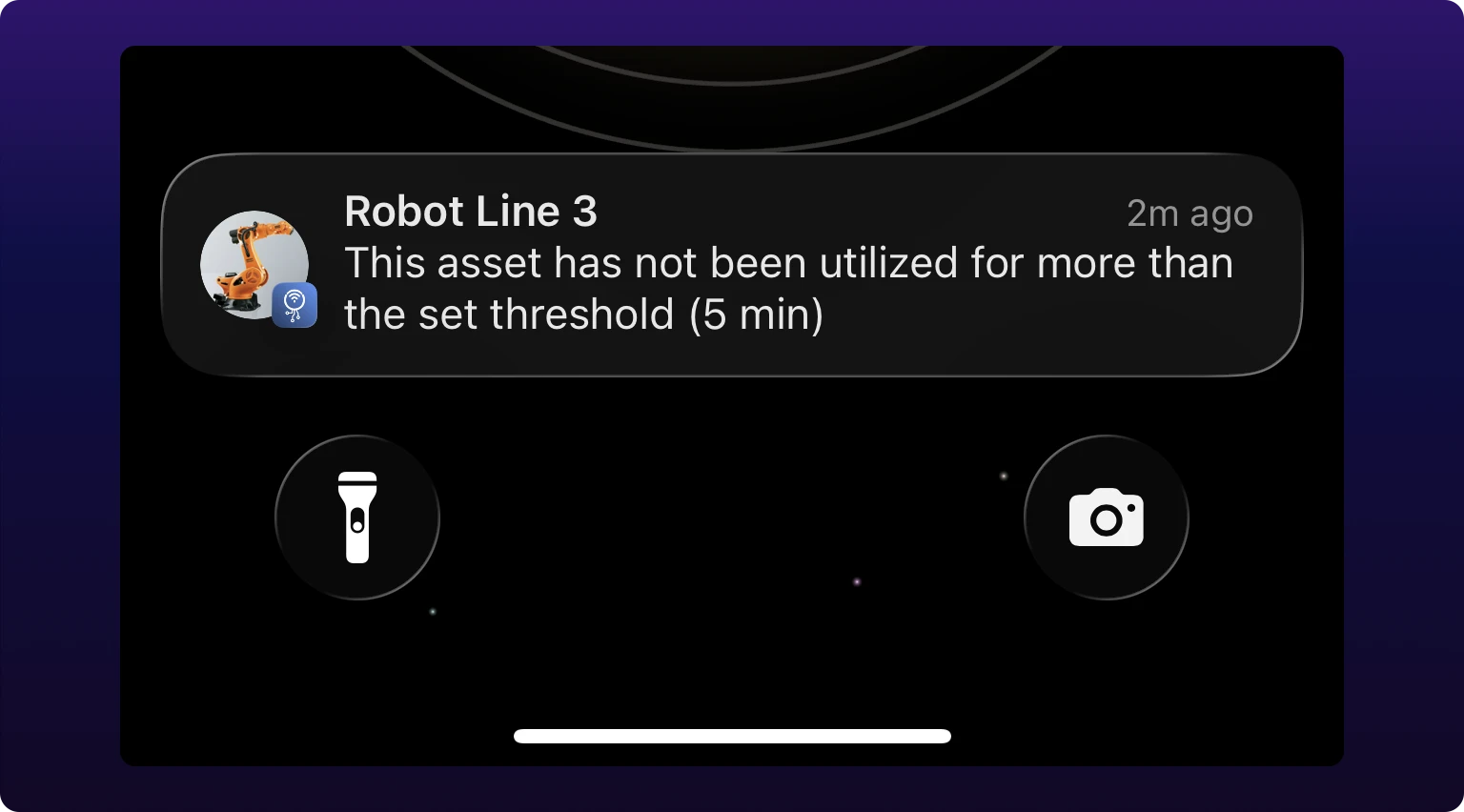 An iPhone lock screen carrying one IoTFlows notification. Its title is the machine's name, and the body reads that the asset has not been utilized for more than the set threshold, with the threshold in minutes in parentheses