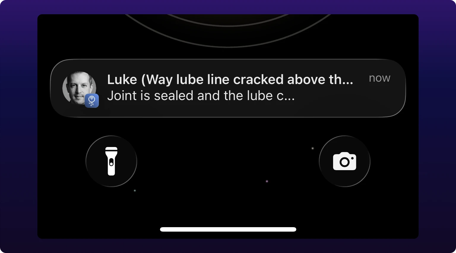 An iPhone lock screen carrying one IoTFlows notification. Its title is the commenter's name followed by the work order's title in parentheses, truncated; the body beneath is the first line of the comment