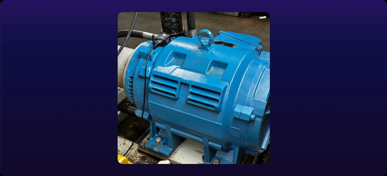 A SenseAi Embedded unit magnet-mounted on the body of a machine motor, with its M12 cable routed away from moving parts